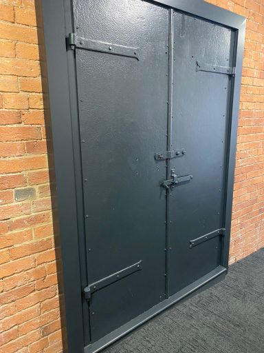 A black door with metal latches